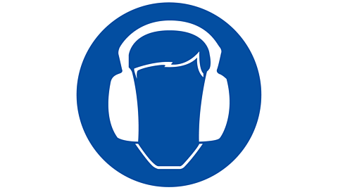 Blue circle surrounding diagram of a head wearing ear defenders