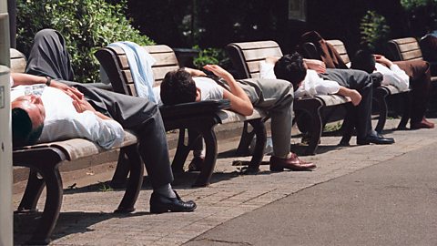 Japanese workers napping on park benches (Credit: Getty Images)