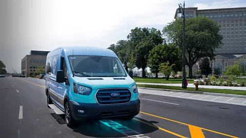 A van drives down 14th Street in Detroit, Michigan, with the position of inductive coils marked on the image digitally (Credit: Electreon)