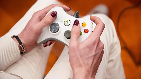 A visitor plays with a controller at the gaming fair "Polaris Convention"