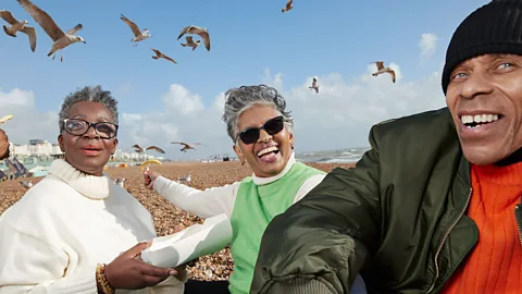 Black senior citizens having fun on a beach (Credit: Getty)