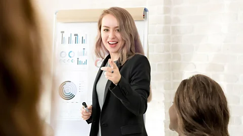 Young businesswoman making a presentation in the meeting