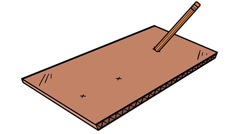 A pencil is poked through a pencil-marked x on the cardboard to make a hole.