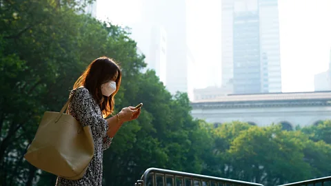 A woman in New York City wears a mask