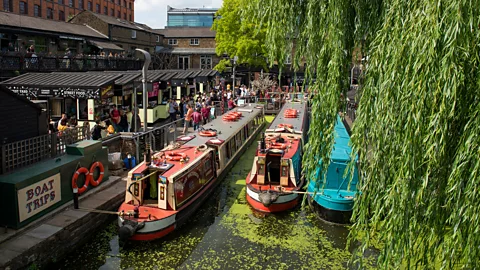 three narrowboats in canal in Camden Market