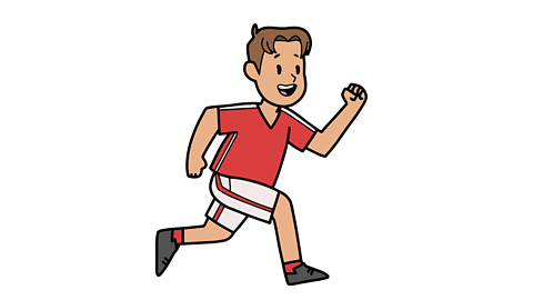 A young boy wearing a red top and white shorts and running