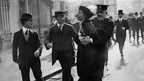 Suffragette being pushed by police officer (Credit: Getty Images)