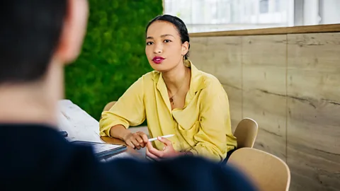 Gen Z with lipstick talking to boss in office