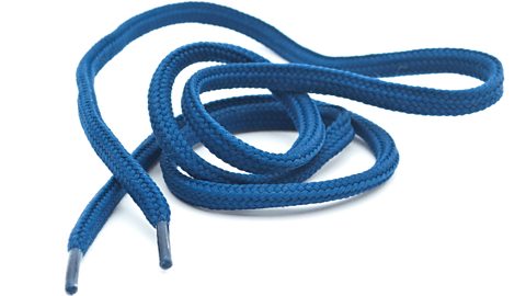 A blue shoelace lying on a white background