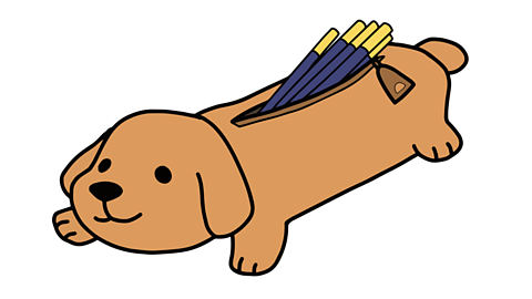 A pencil case shaped like a brown smiling dog. Pencils sticking out of the open zip.