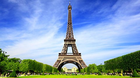 The Eiffel Tower with a crowd of people at the base