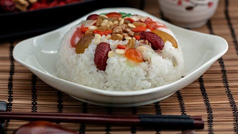 A bowl of rice with nuts and fruit