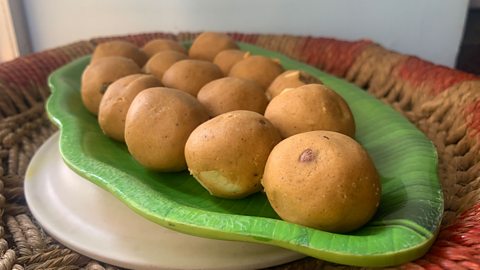 A plate of small round dumplings on a green plate