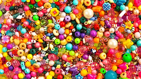 Close up of many colourful beads in different shapes and sizes