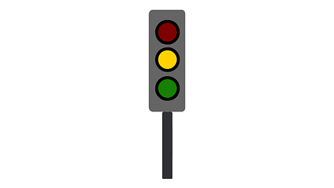 A traffic light with the amber light lit up in the middle. The green and red lights are off.