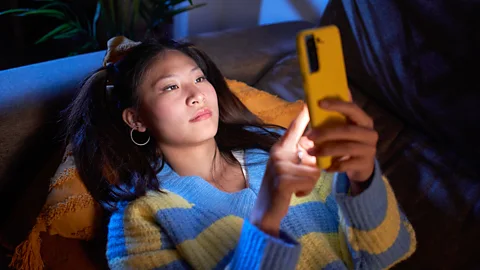 Girl scrolling on phone (Credit: Getty Images)