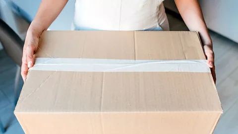 Woman holding a large box (Credit: Getty Images)