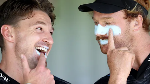 Two rugby players applying suncream during a training session in New Zealand (Credit: Getty Images)