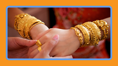 A woman wearing gold jewellery. 