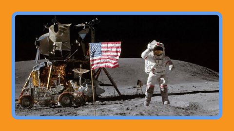 NASA astronaut John Young in a space suit on the moon jumping next to the lunar lander.