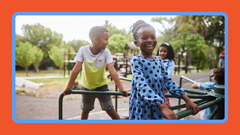 Children at the park on a merry-go-round
