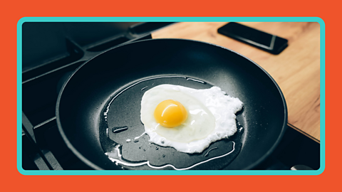 An egg cooked in a frying pan.