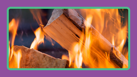 Wood burning on a fire.