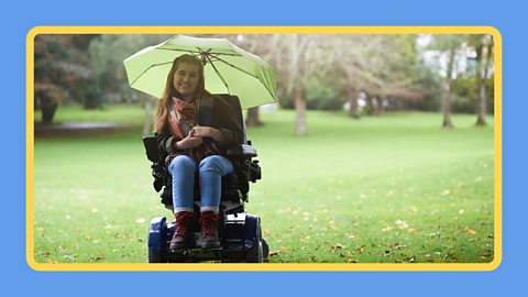 A girl in a mobility wheelchair with an umbrella in the rain.