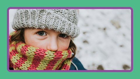 A young girl wearing a wool hat and scarf.