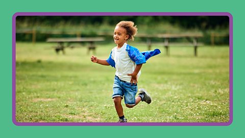A boy running through a field.