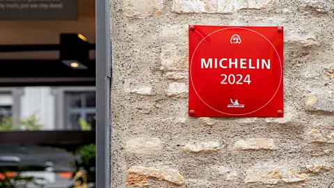 Stone wall next to an open door with a plaque that says 'Michelin 2024' (Credit: Alamy)