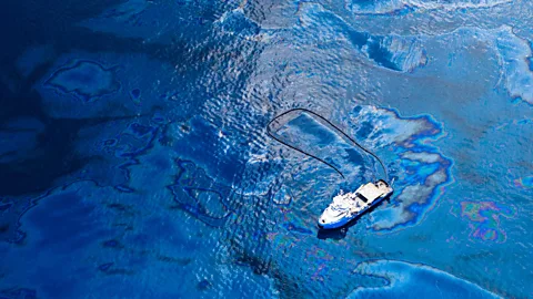 A skimmer boat corrals oil after the Deepwater Horizon spill (Credit: Getty Images)