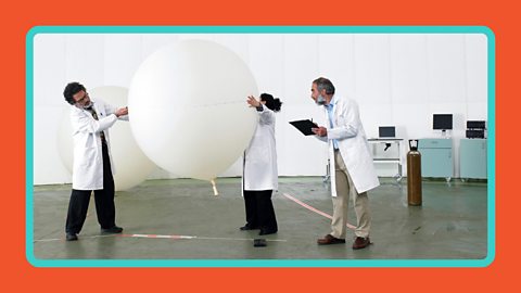 Three scientists conducting a science experiment with baloons.