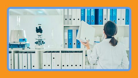 A scientist checking research in a lab.