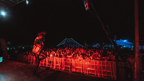 A musician performing on stage in front of the crowd at the Stendhal music festival in Limavady.