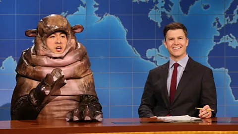 Bowen Yang as Moo Deng and Colin Jost on SNL (Credit: Getty Images)