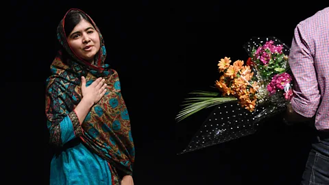 Malala Yousafzai receives flowers after winning the Nobel Prize for peace (Credit: Getty Images)