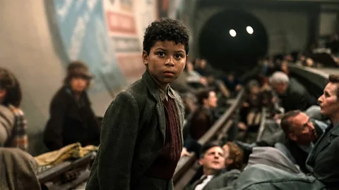 Still of Elliott Heffernan playing a young boy taking shelter in a London Tube station in Blitz (Credit: Apple TV+)