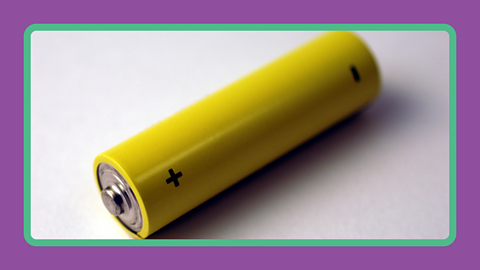 A small battery cell with positive and negative on the side.