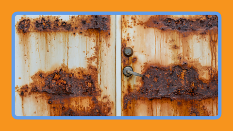 Rust gathering on the side of a metal shipping container.