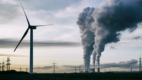 Power station plumes in Germany next to windmill (Credit: Getty Images)