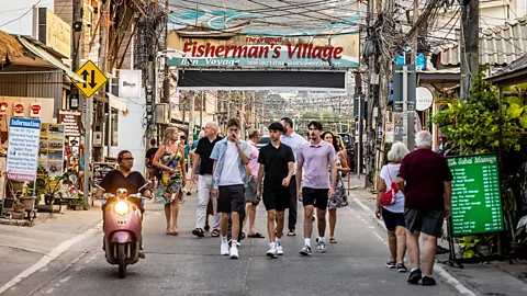 Travellers walking on the streets of Thailand (Credit: Getty Images)