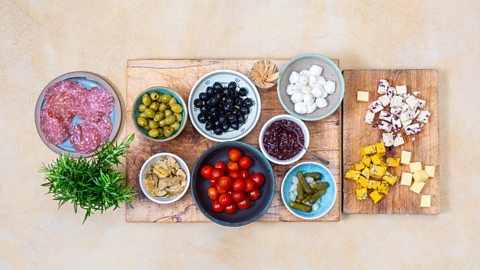Charcuterie ingredients in bowls