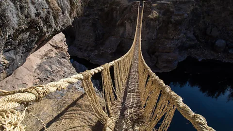 A woven suspension bridge going across a gorge (Credit: Alamy)