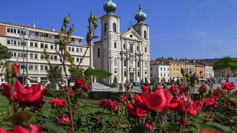 Church of Saint Ignatius with red roses in the foreground, Gorizia (Credit: Getty Images)