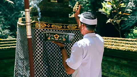 Balinese Performing a Melukat Purification Ritual (Credit: Getty Images)