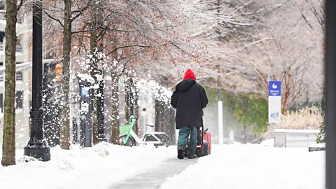 Snow is cleared from a path in Atlanta, Georgia (Credit: Getty Images)