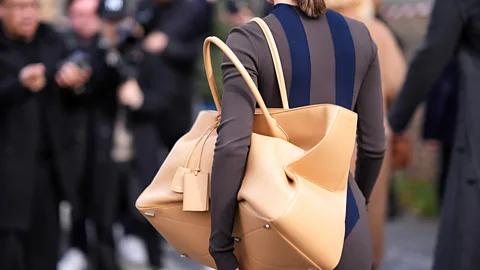 A woman wearing an oversized handbag over her shoulder (Credit: Getty Images)