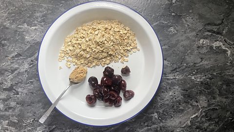 Porridge ingredients: Oats, cherries, a teaspoon of peanut butter 