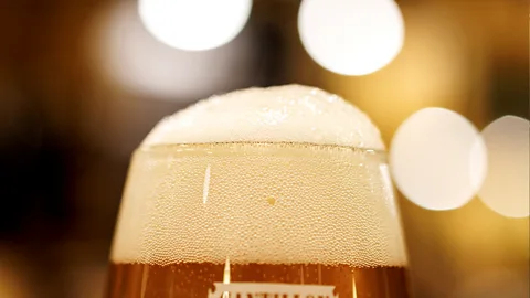 A close-up photo of a foamy beer (Credit: Getty Images)